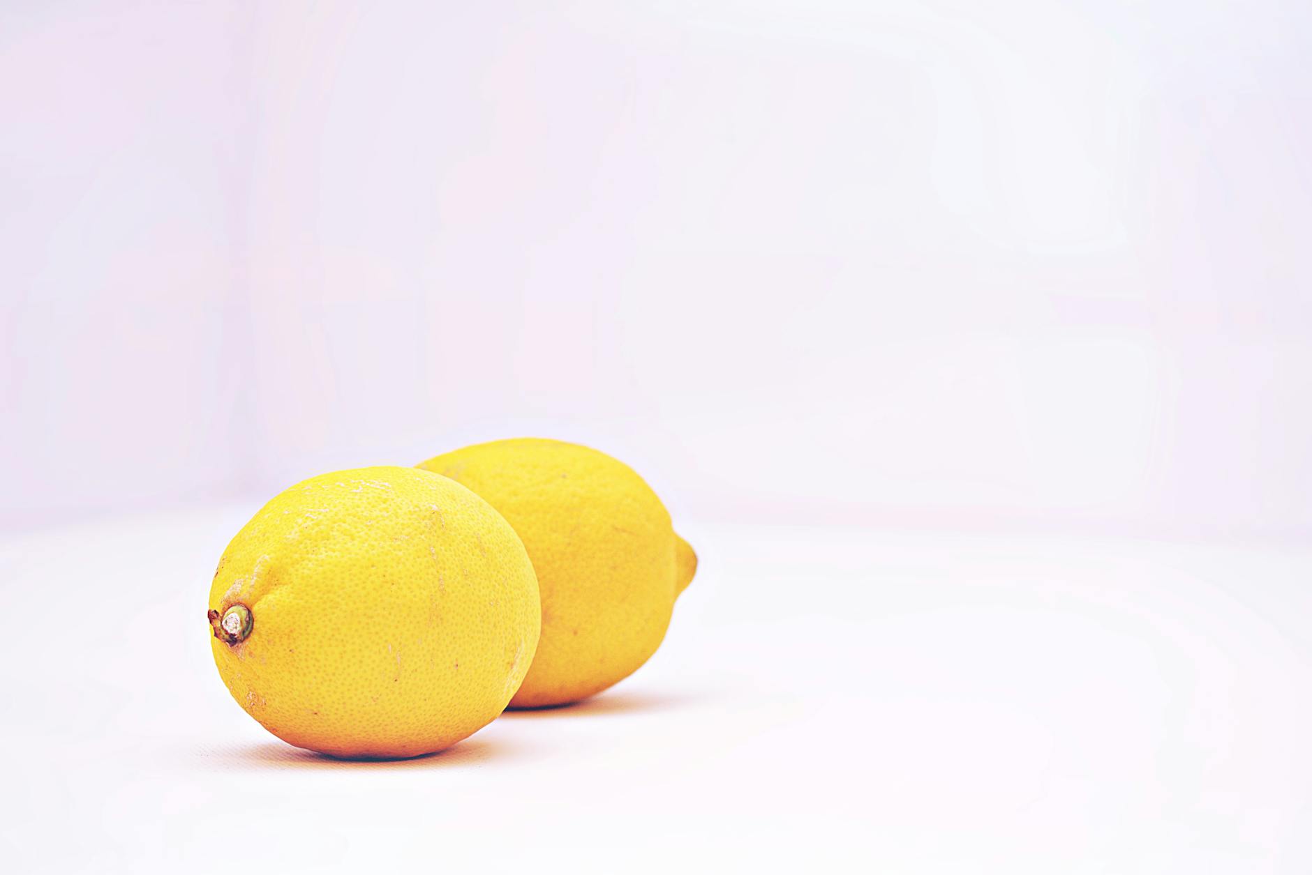 Two vibrant lemons on a white background, symbolizing fresh approaches to postpartum intimacy