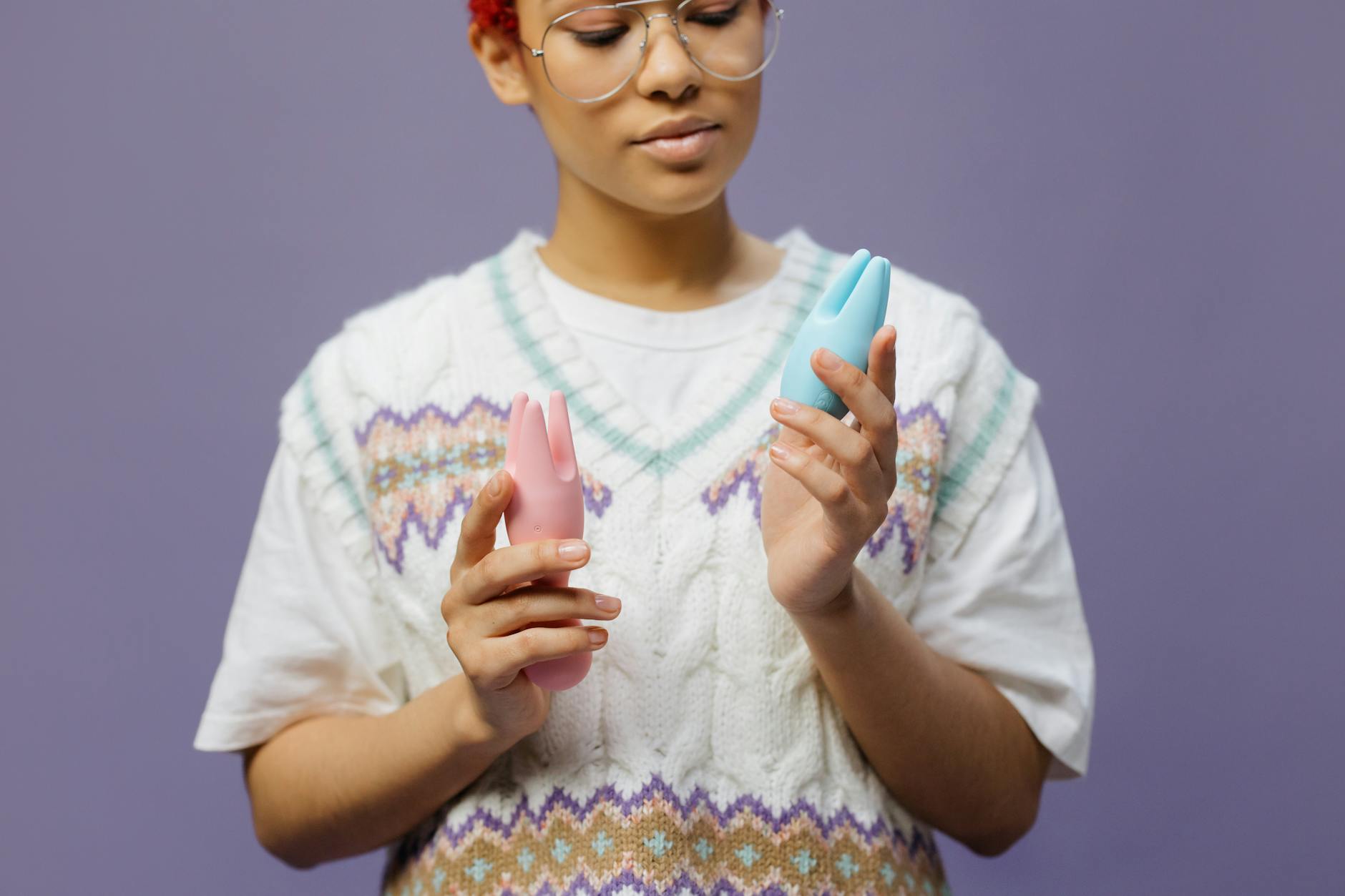 Woman holding a blue silicone vibrator, contemplating shared intimacy and pleasure exploration.