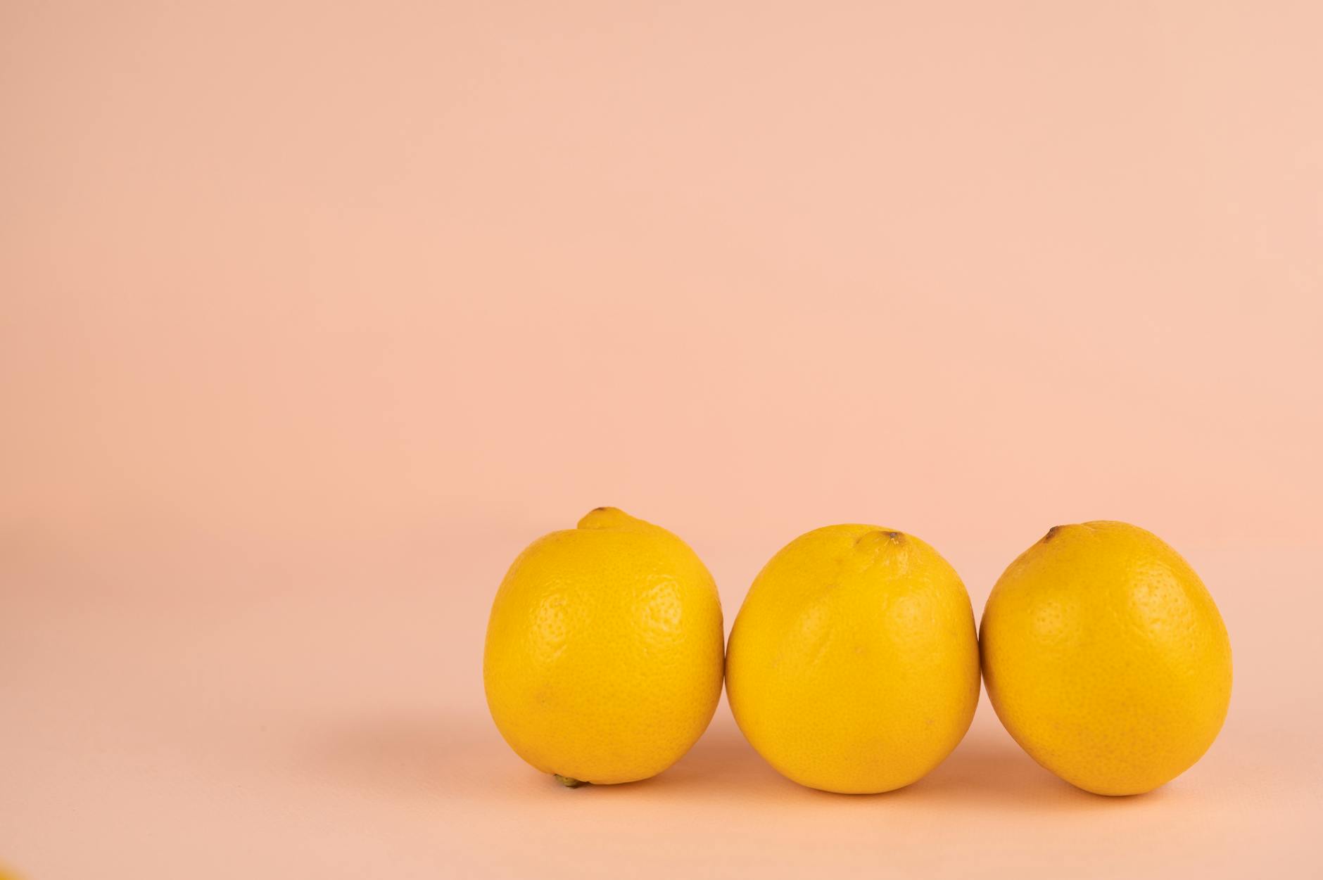 Bright ripe lemons on a pastel background, symbolizing natural restoration and vitality