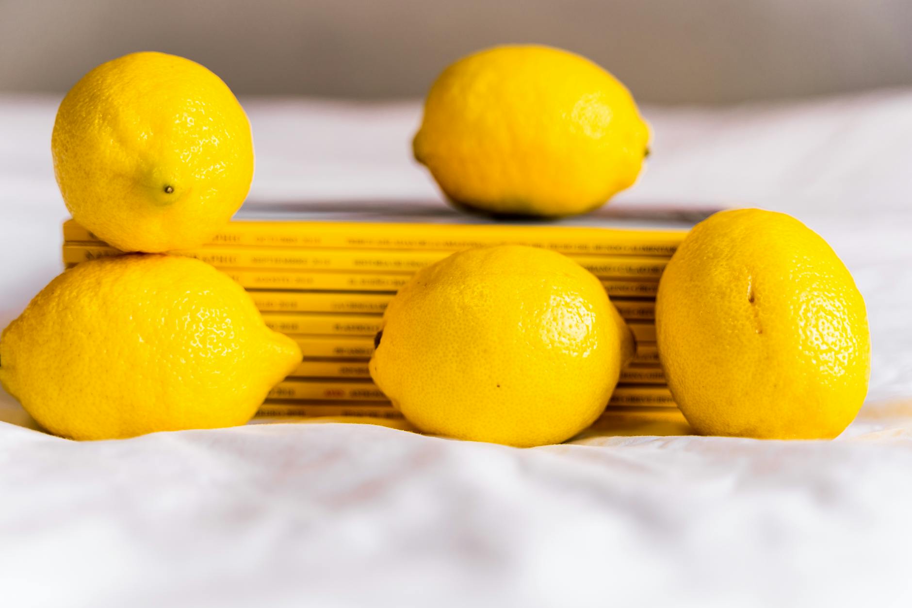 Two fresh lemons held in cupped hands on a brown surface, symbolizing openness and care in intimate conversations